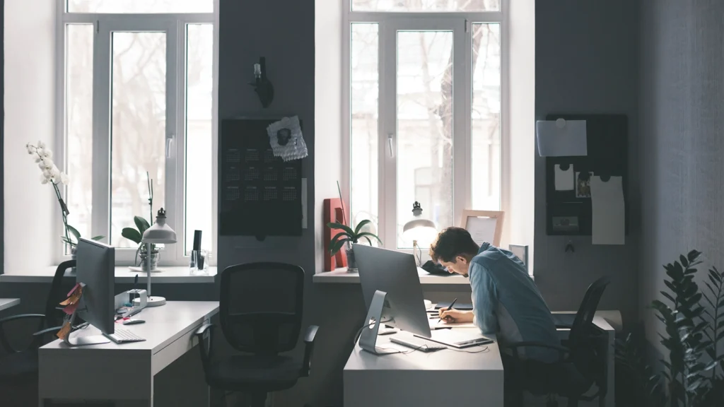 modern office workspace with large windows letting in natural light. A person is sitting at a desk, working on a data flow diagram, with a computer monitor in front of them. The workspace is minimalist, featuring potted plants, desk lamps, and a tidy arrangement of office supplies. The setting conveys a focused and productive atmosphere, ideal for tasks such as data flow diagram creation or other detailed work. modern office workspace with large windows letting in natural light. A person is sitting at a desk, working on a data flow diagram, with a computer monitor in front of them. The workspace is minimalist, featuring potted plants, desk lamps, and a tidy arrangement of office supplies. The setting conveys a focused and productive atmosphere, ideal for tasks such as data flow diagram creation or other detailed work.