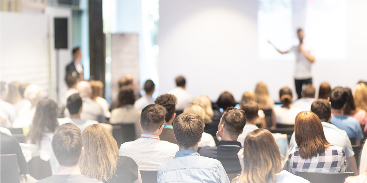 Man Presenting to a Room Man Presenting to a Room