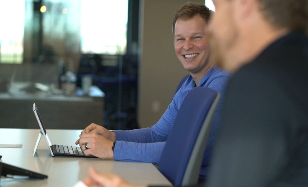 Two Men Conducting a Risk Assessment in an Office with Numerous Windows