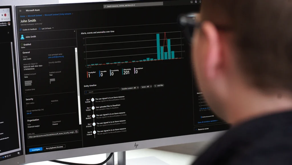 Security Operations Center (SOC) Analyst working at a computer.