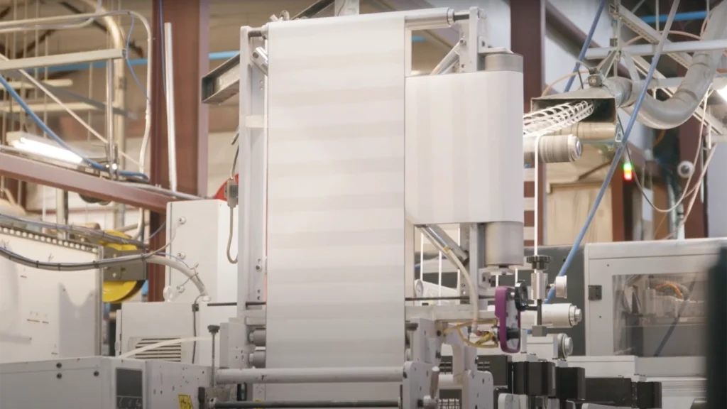 Industrial machinery in a manufacturing facility, featuring automated equipment and large rolls of material in production, supported by private cellular networks for seamless operations. Industrial machinery in a manufacturing facility, featuring automated equipment and large rolls of material in production, supported by private cellular networks for seamless operations.