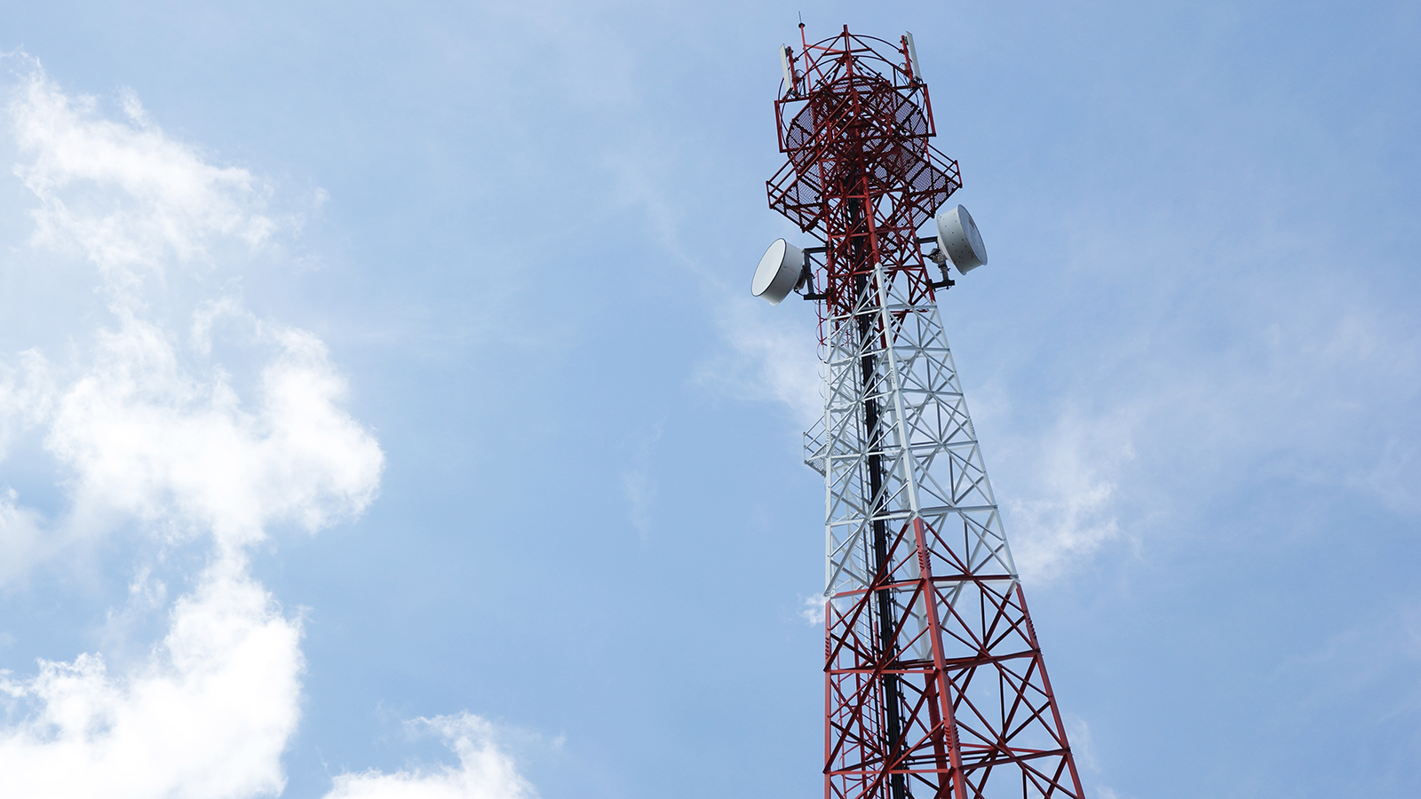 A telecommunications tower against a blue sky, representing critical infrastructure targeted during the 2024 cyberattack campaigns, including the Salt Typhoon espionage campaign.