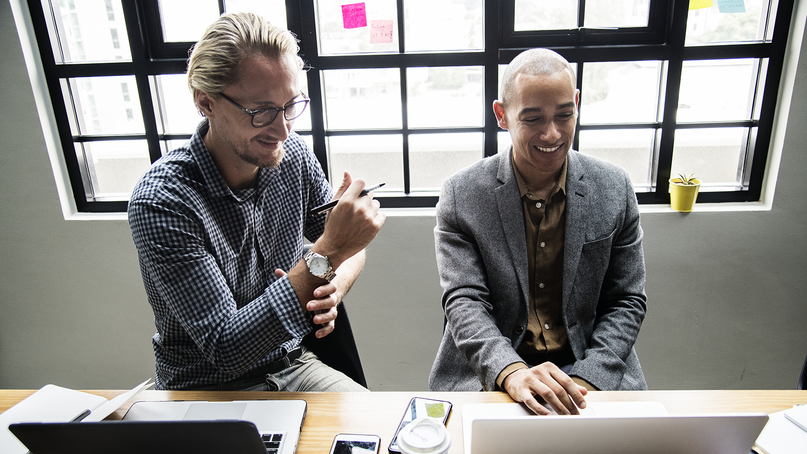 Two business professionals discussing AI liability insurance coverage options