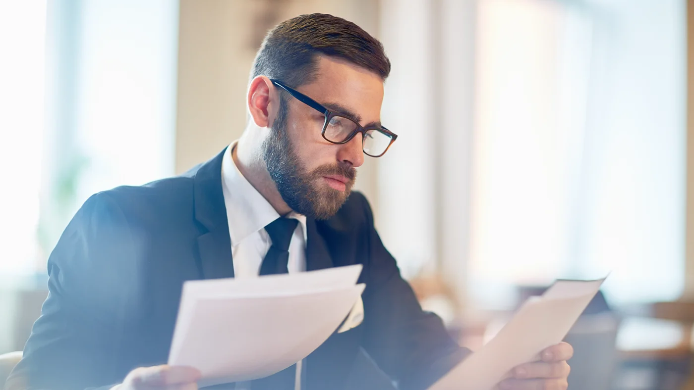 Business professional carefully reviewing AI liability insurance documents
